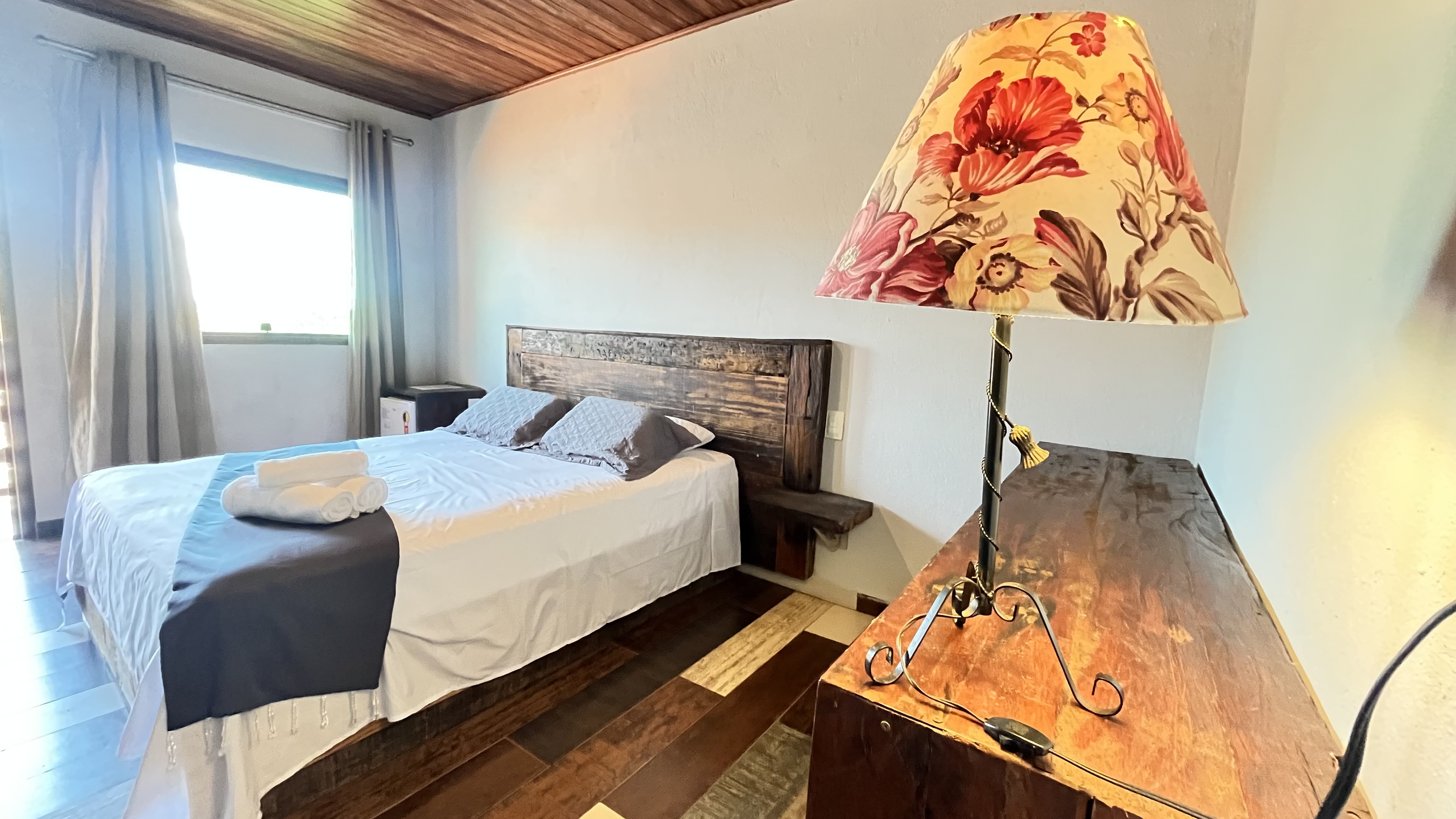 Quarto confortável com cama de casal e iluminação ambiente